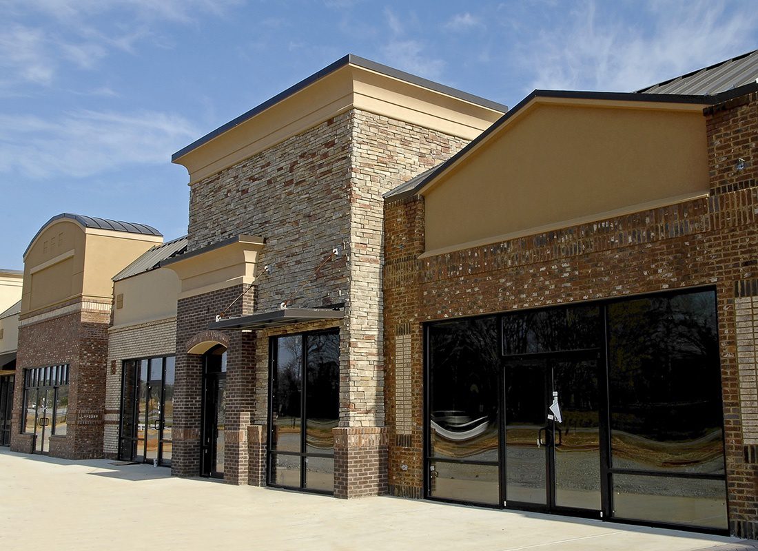 Business Insurance - Exterior View of a Newly Constructed Brick Commercial Property with Multiple Office and Retail Spaces